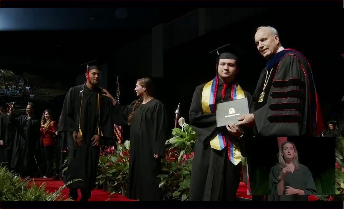 Sebastian receiving his diploma on stage at the University of Tampa commencement, 2019